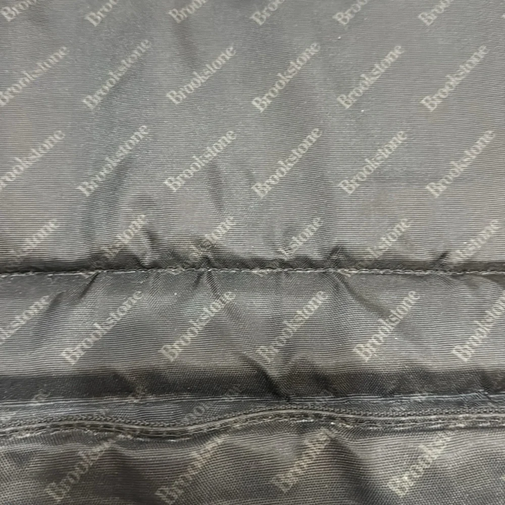 Brookstone black neoprene waterproof lap top bag with detachable shoulder strap.